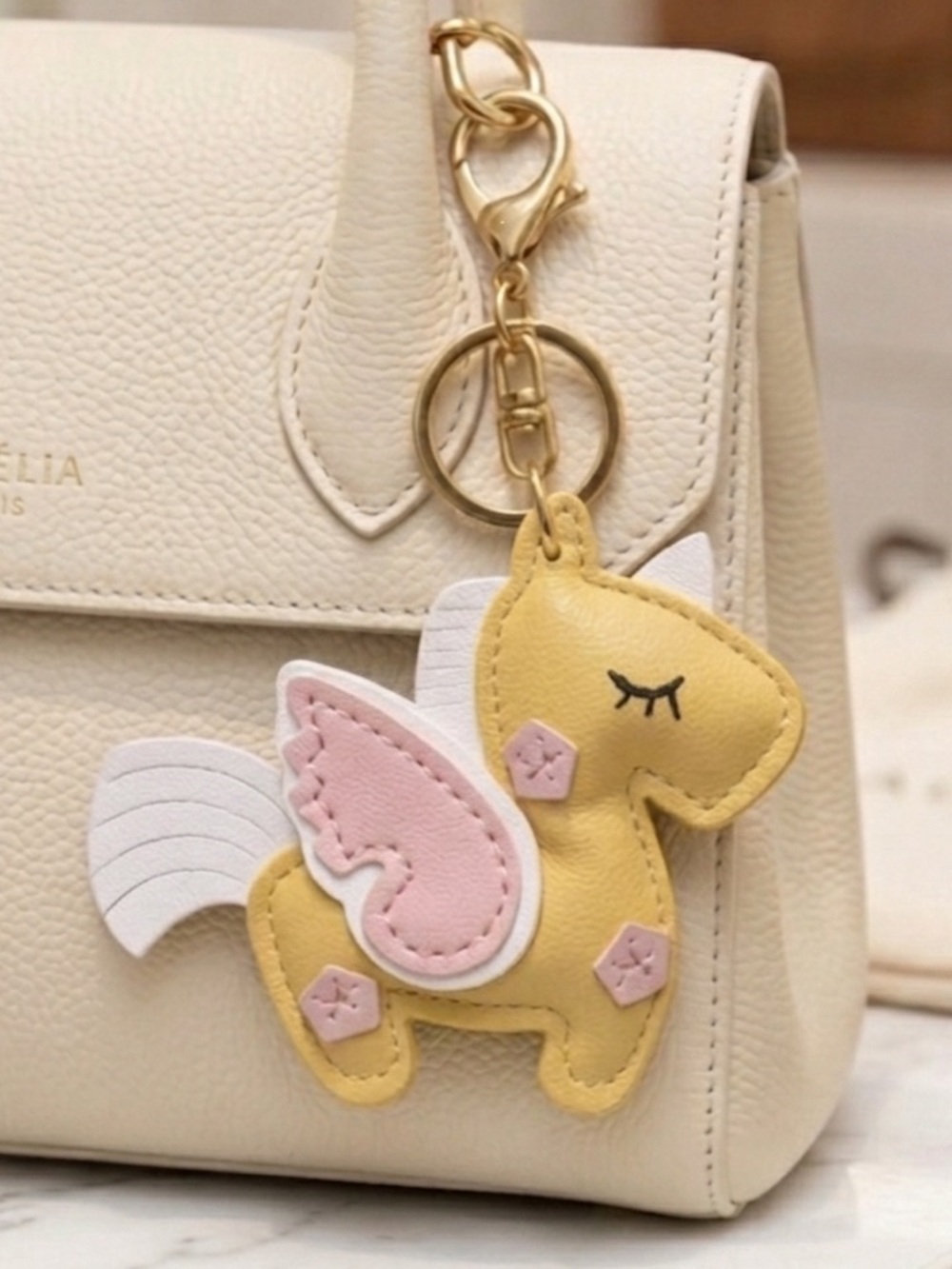 Unbranded Yellow Unicorn Keychain with pink accents New (bag not included)
